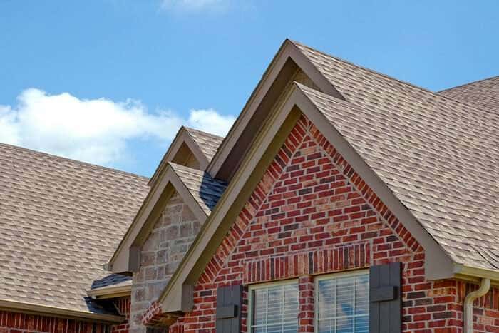Architectural asphalt shingles on a brick home with dormers