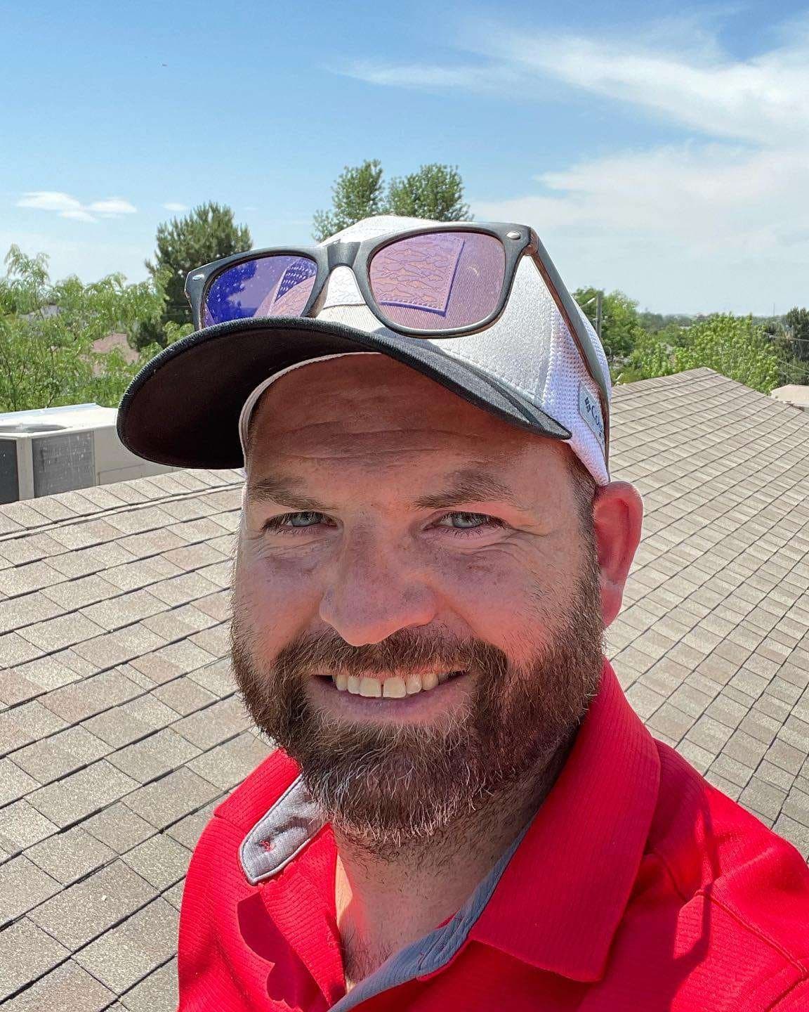 Matt with Redline Roofing on a roof during a free inspection