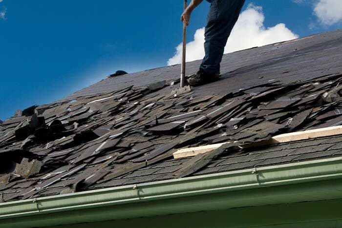 Old shingles torn off ahead of a storm-damage replacement