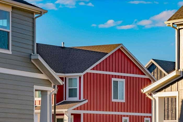 Red and gray siding on a row of new homes